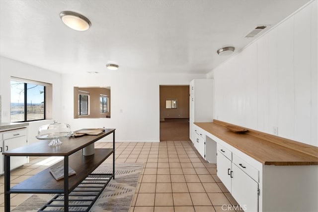 kitchen with white cabinets and light tile patterned floors