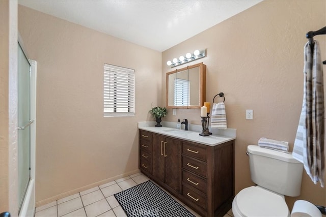 full bathroom featuring tile patterned floors, toilet, bath / shower combo with glass door, and vanity