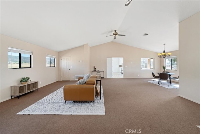 carpeted living room featuring lofted ceiling, ceiling fan with notable chandelier, and a wealth of natural light