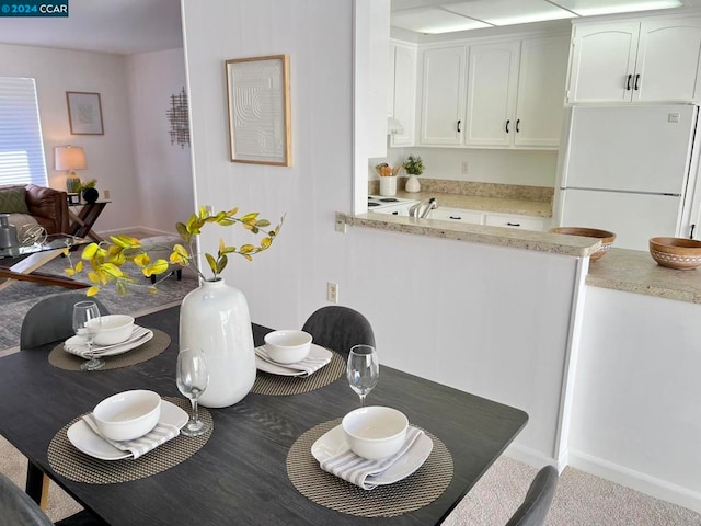 dining space with light carpet