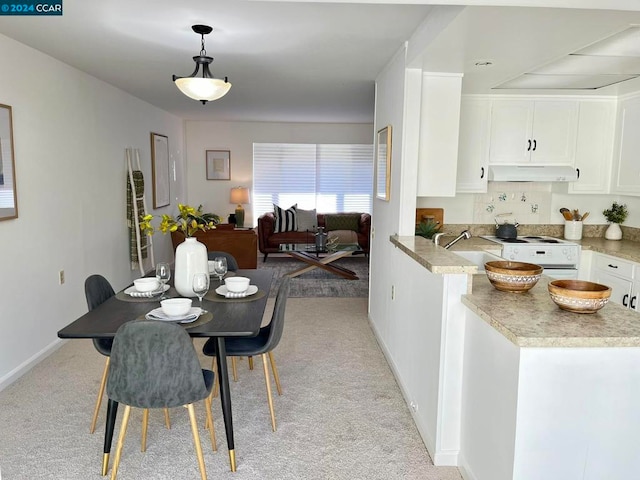 carpeted dining area with sink