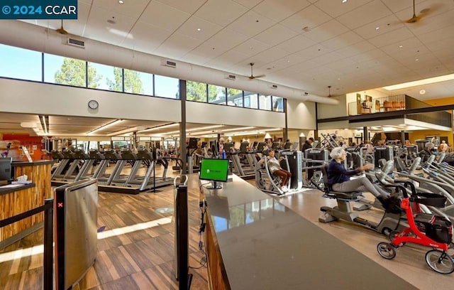 workout area featuring a towering ceiling