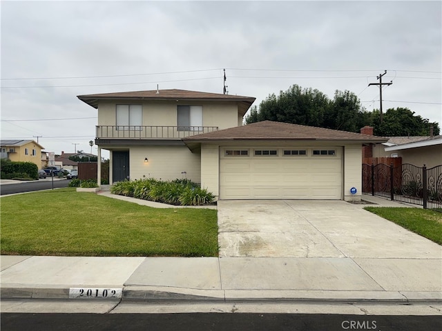 view of front facade with a front lawn, a balcony, and a garage