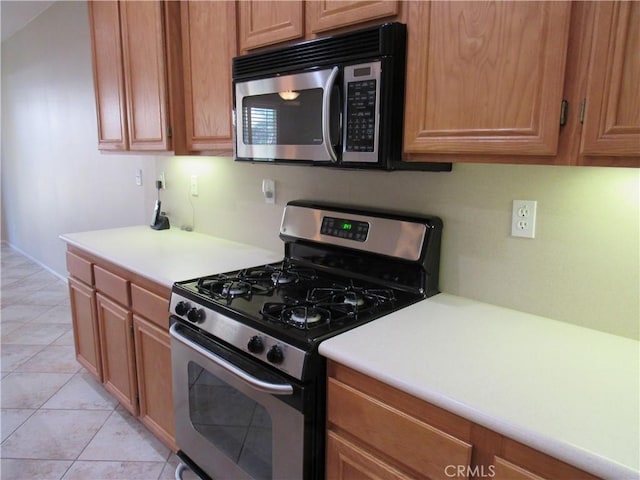 kitchen with light tile patterned floors and appliances with stainless steel finishes