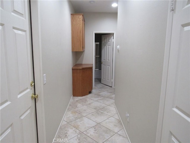 hall featuring light tile patterned floors