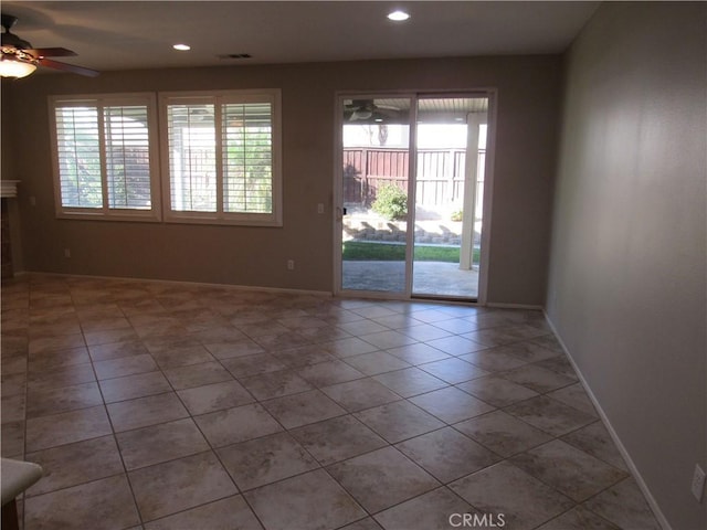 unfurnished room with ceiling fan and light tile patterned flooring