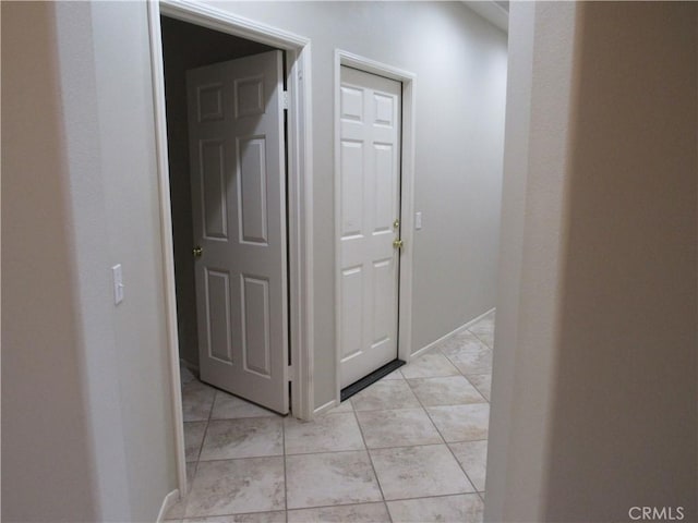 corridor featuring light tile patterned floors