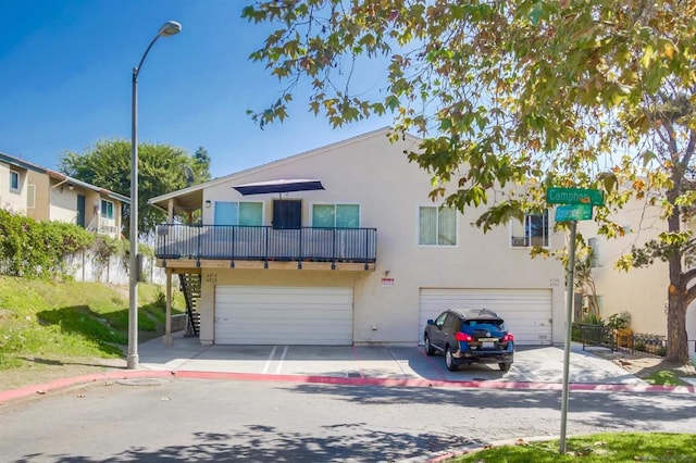 view of front of home with a balcony and a garage