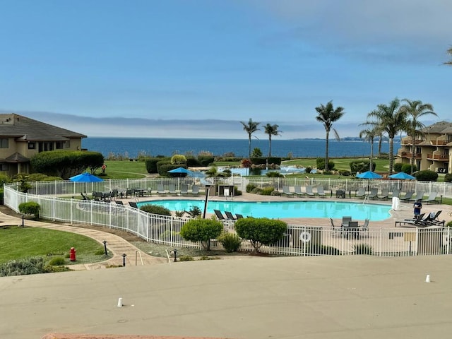 view of pool featuring a water view and a patio area