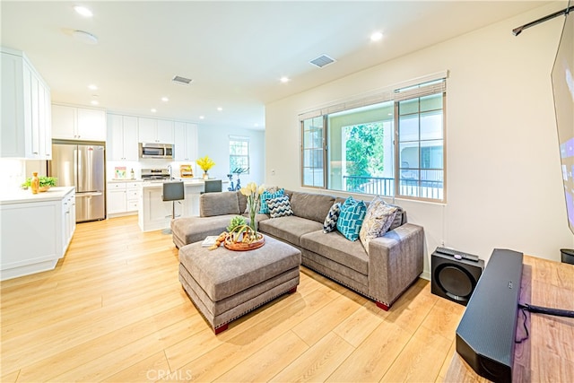 living room with light hardwood / wood-style flooring