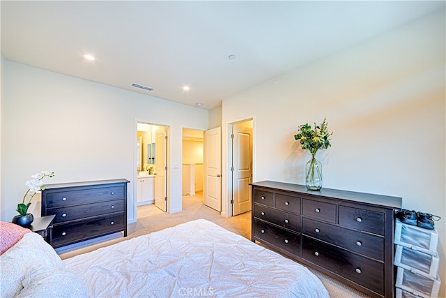 carpeted bedroom featuring ensuite bath