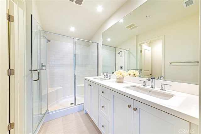 bathroom featuring walk in shower, vanity, and tile patterned floors