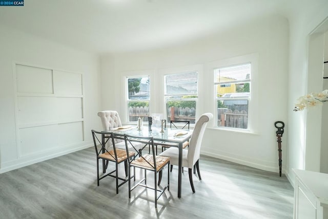 dining room with light wood-type flooring and a wealth of natural light