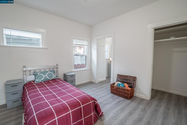 bedroom featuring hardwood / wood-style floors and a closet