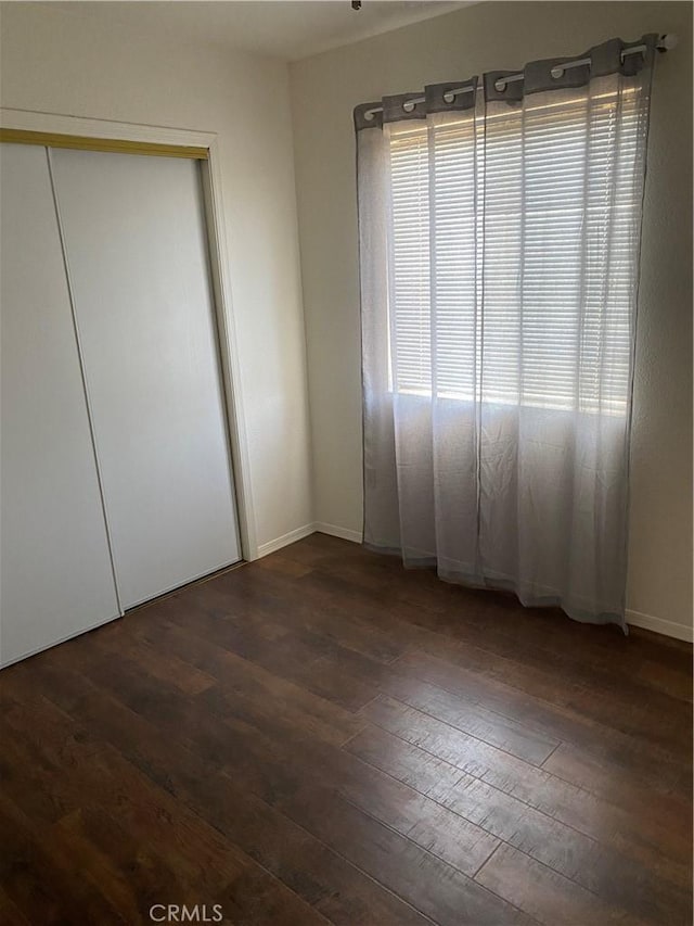 unfurnished bedroom with dark hardwood / wood-style floors