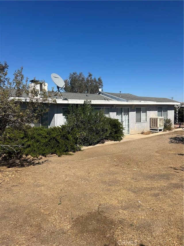 back of house featuring cooling unit