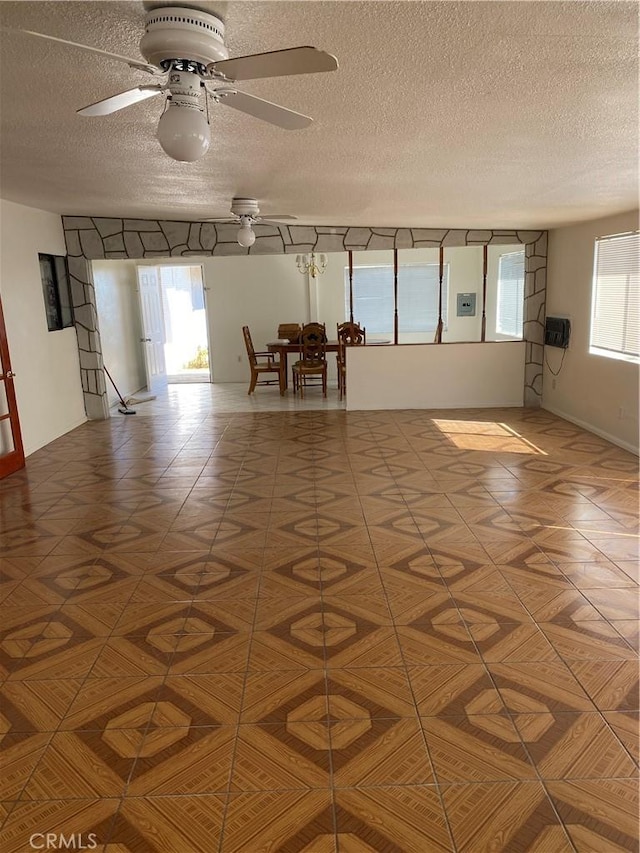 spare room featuring ceiling fan and a textured ceiling