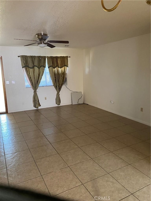 unfurnished room featuring a textured ceiling, tile patterned floors, and ceiling fan