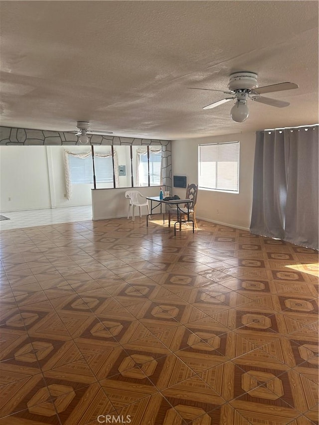 spare room featuring ceiling fan and a textured ceiling