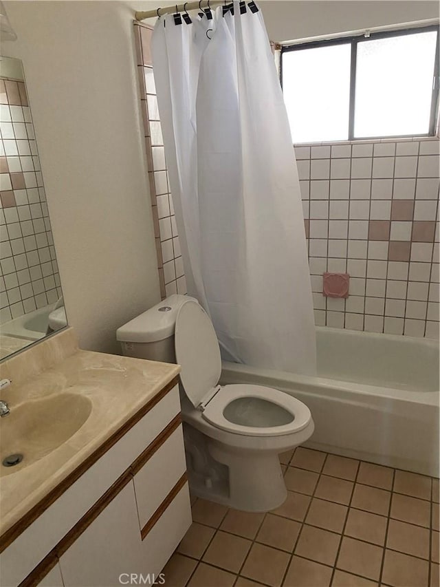 full bathroom with vanity, tile patterned flooring, shower / bathtub combination with curtain, and toilet