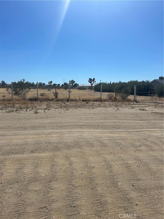 view of yard with a rural view