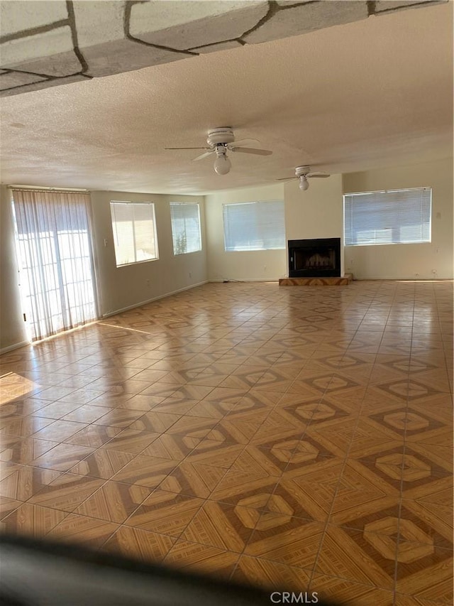 unfurnished living room with light parquet floors and ceiling fan