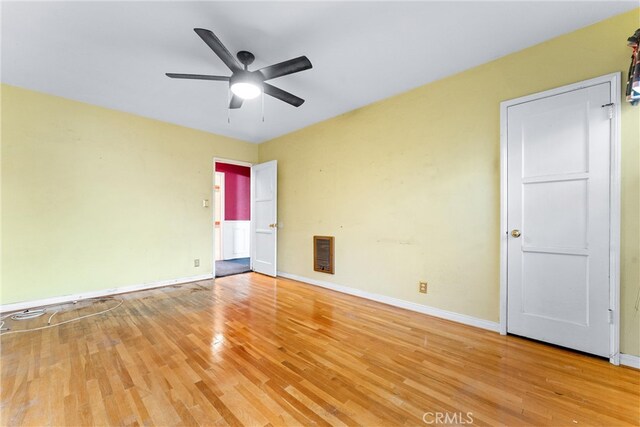 empty room featuring wood-type flooring and ceiling fan