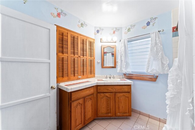 bathroom with tile patterned floors and vanity