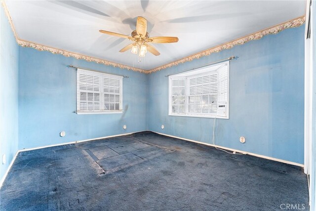 carpeted empty room featuring ceiling fan