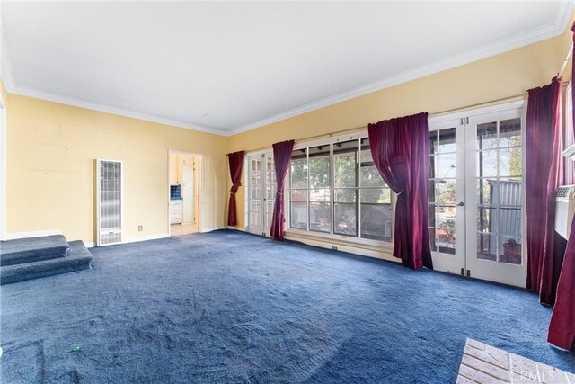 unfurnished living room featuring crown molding, french doors, and carpet flooring