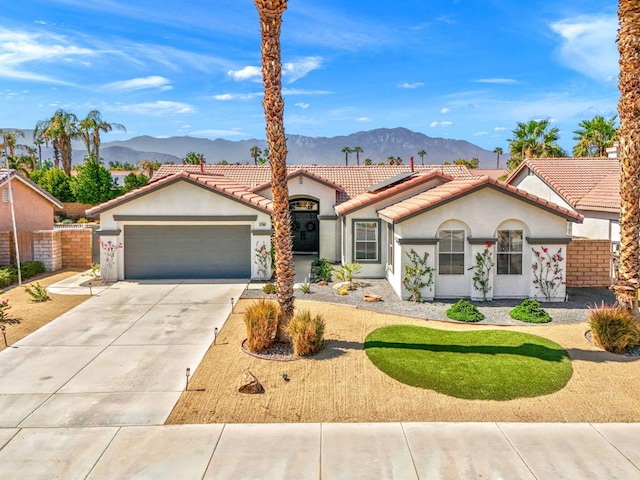 view of front of house with a mountain view and a garage