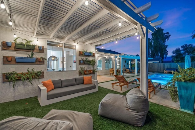 patio terrace at dusk with a pergola and outdoor lounge area