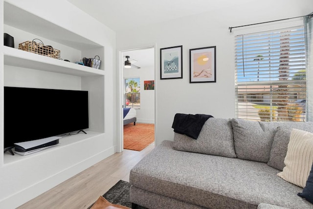 living room featuring ceiling fan and hardwood / wood-style floors