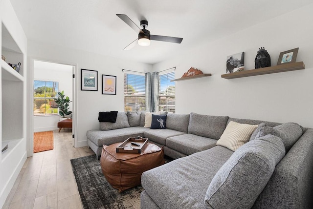 living room with ceiling fan and light hardwood / wood-style floors