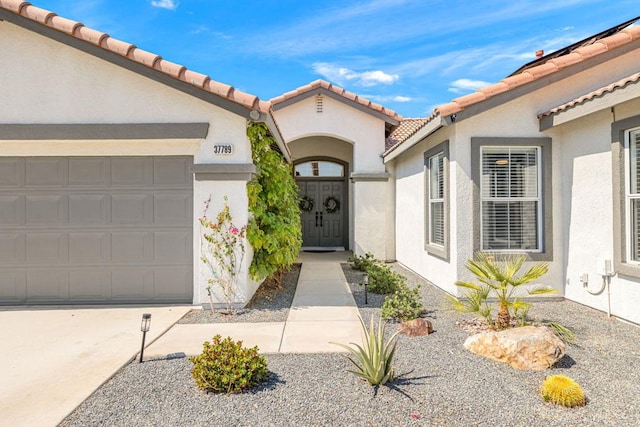 view of exterior entry with a garage