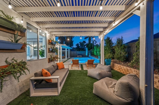 patio terrace at dusk with a pergola and a lawn