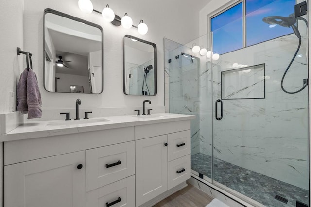 bathroom with ceiling fan, a shower with door, vanity, and wood-type flooring