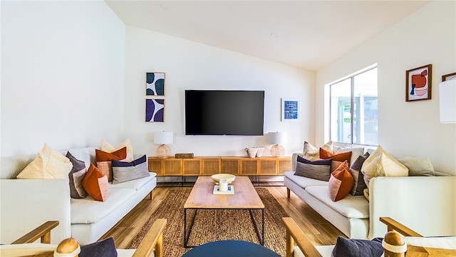 living room featuring vaulted ceiling and hardwood / wood-style flooring