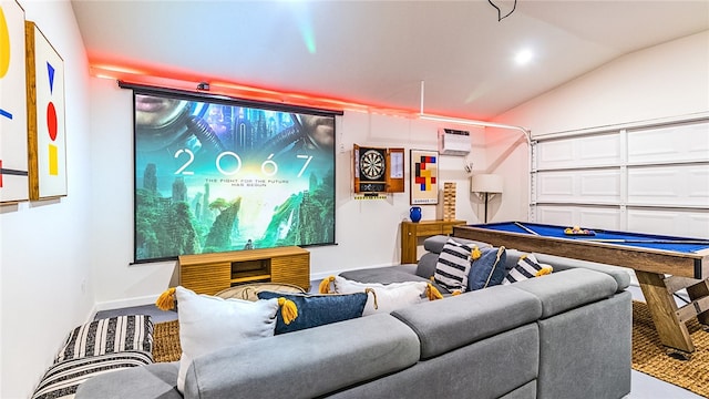 cinema room featuring a wall unit AC and vaulted ceiling