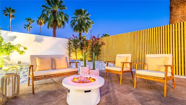 view of patio featuring an outdoor living space with a fire pit