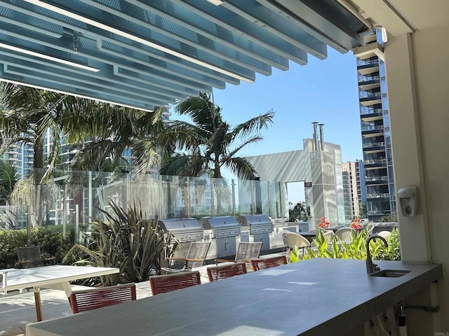 view of patio with exterior kitchen, grilling area, and sink