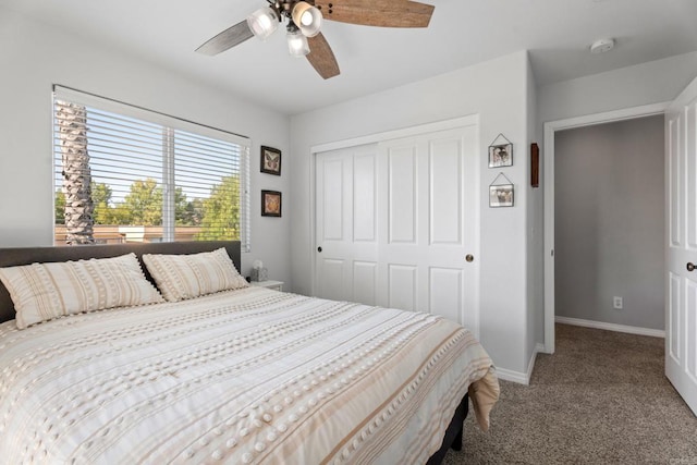 carpeted bedroom with ceiling fan and a closet