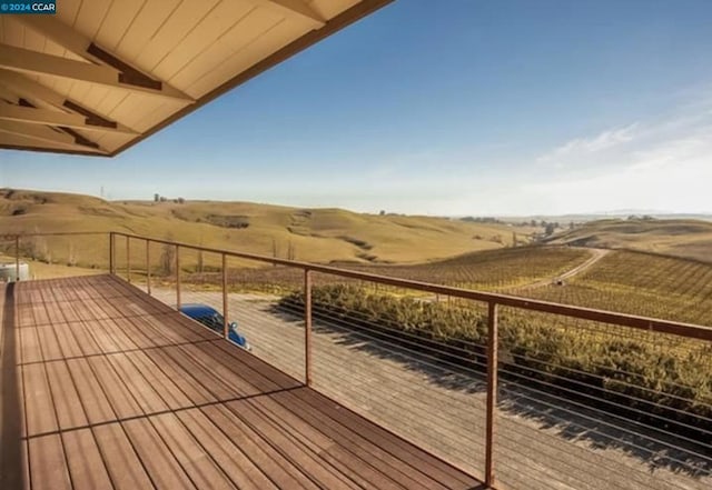 wooden deck with a rural view