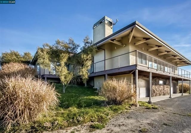 view of side of property featuring a patio area