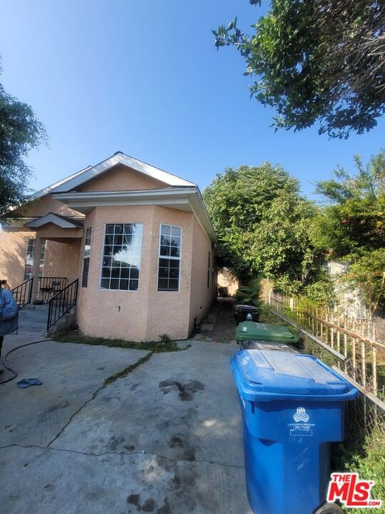 view of property exterior with a patio area