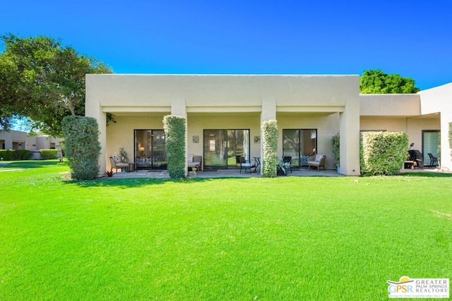 back of house featuring a yard and a patio