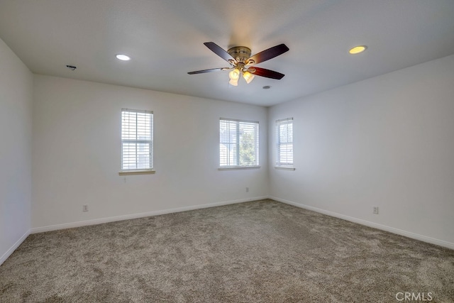 spare room with carpet floors and ceiling fan