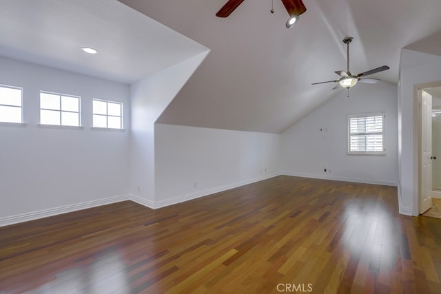 bonus room featuring a healthy amount of sunlight, vaulted ceiling, dark wood-type flooring, and ceiling fan