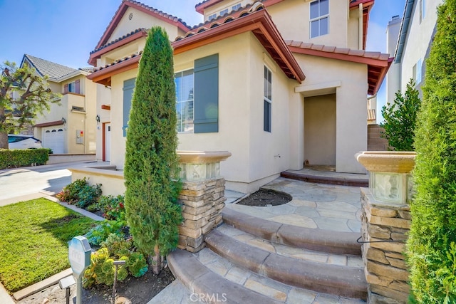 mediterranean / spanish-style home with a garage