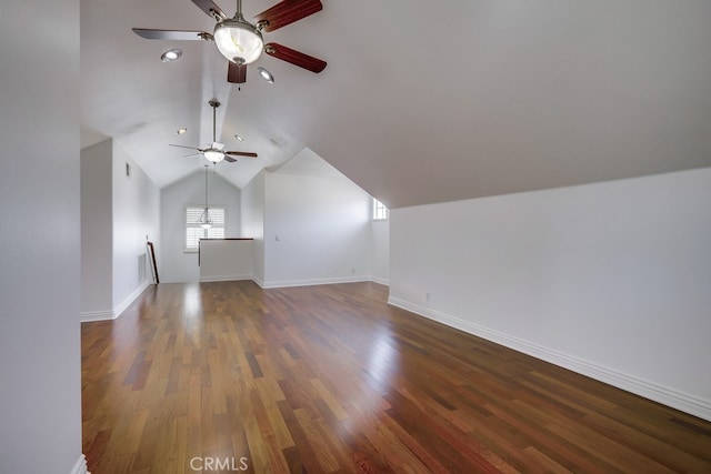 additional living space featuring vaulted ceiling and dark hardwood / wood-style floors